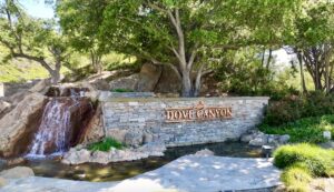 Beautiful landscape scene of the entrance to Dove Canyon, with water fall and Dove Canyon sign.